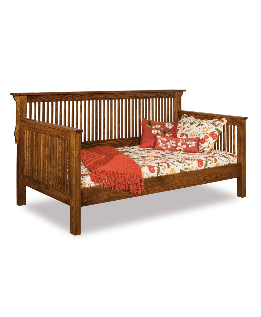 Wooden daybed with floral bedding and a red blanket on a white background